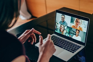 Over the shoulder view of a Woman engaged in a virtual meeting