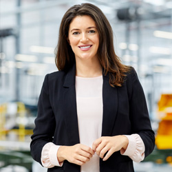 Professional woman within a warehouse smiling