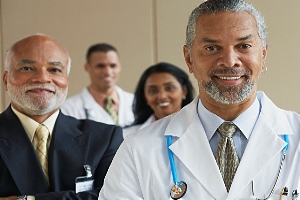 Group of MBA healthcare professionals in white coats and business suits